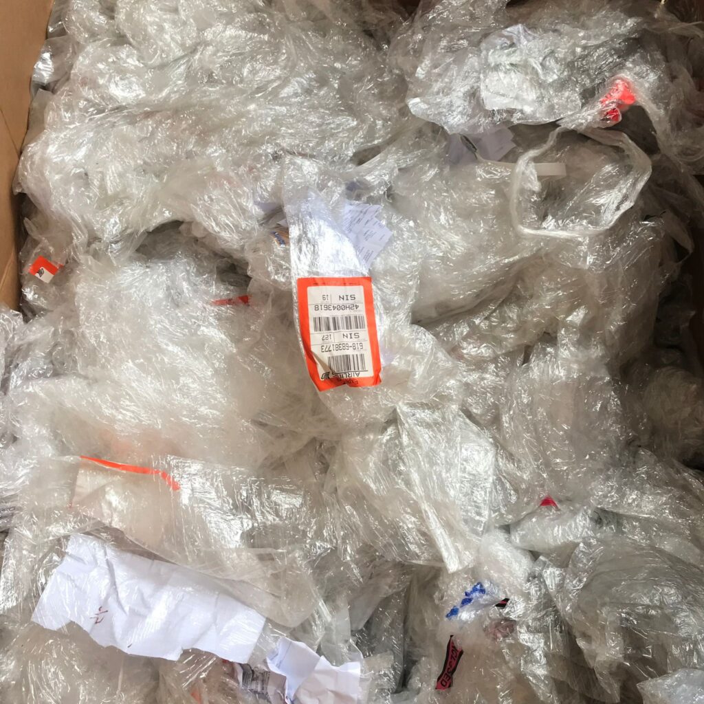 PE film and pallet stretch wrap with stickers and labels that need to be removed before recycling in Singapore.